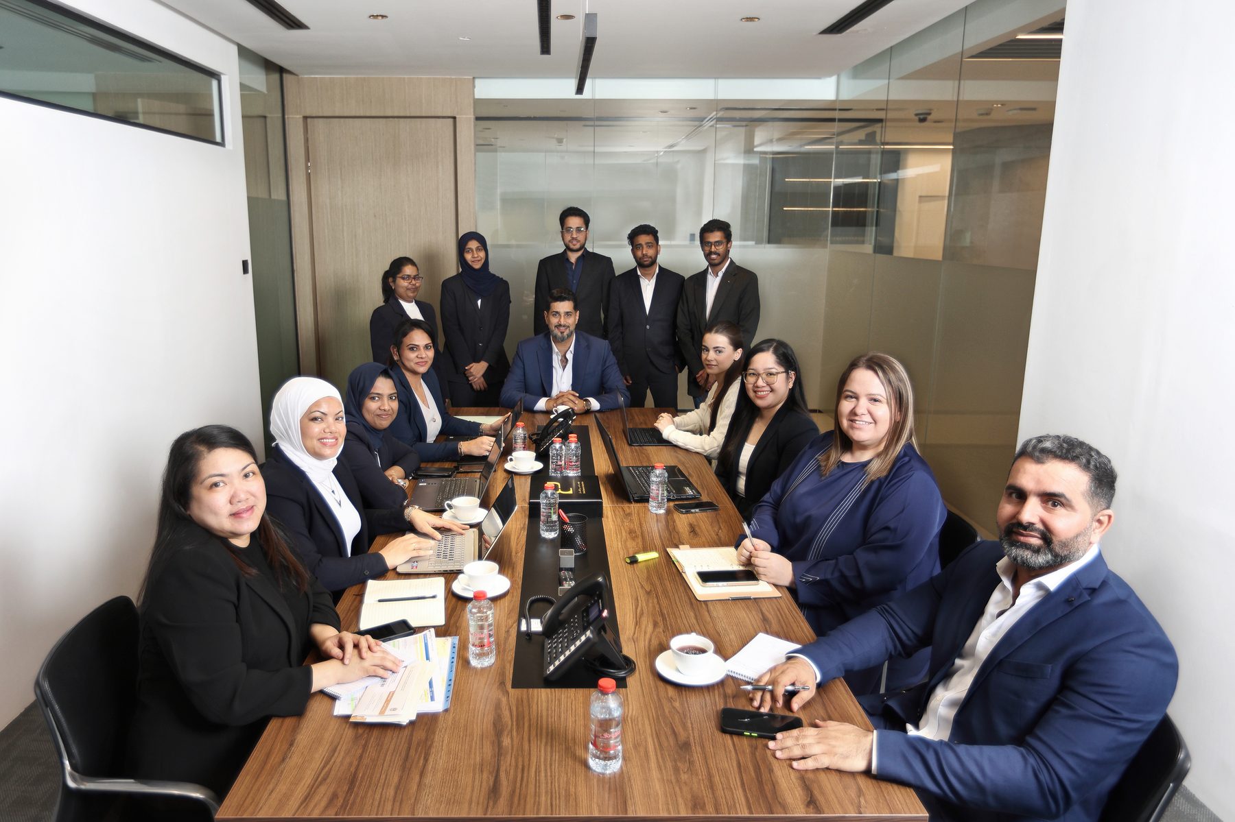 The Dubai Business Corporation team around the boardroom table at Office 3402, with Ali Jasim at the head